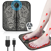 EMS foot massager pad with circuit board pattern, digital display, wireless remote, showing blue electrical stimulation visualization and red heat therapy arrows on user's leg and arm