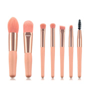 All 7 pink makeup brushes arranged by size on white background showing the full set