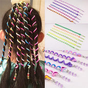 Child model wearing dark hair styled with multiple bright spiral curlers in pink, blue, yellow, and other vibrant colors creating defined wave patterns