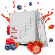 Product box with stick packets surrounded by fresh berries, dynamic red liquid splashes, and ingredient fruits