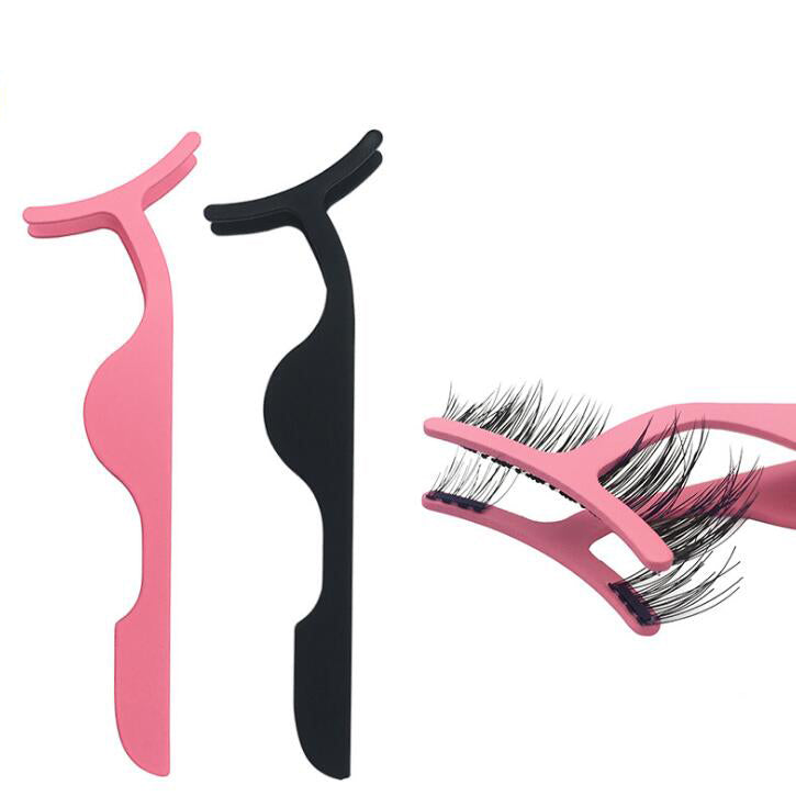 Pink and black false eyelash applicator tweezers side by side on white background, with a close-up inset showing the pink tweezer gripping a false lash strip