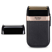 Kemei KM-2024 electric razor shown at angle with removable foil head displayed separately