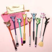 Full 9-piece Eeveelution makeup brush set fanned out on pink background with pink and gold storage pouches