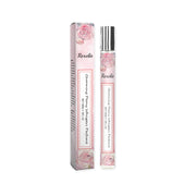 Product shot showing Roxelis fragrance bottle and outer box with peony rose illustrations in soft pink palette