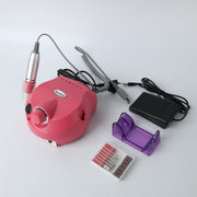 Complete nail grinder kit with pink machine, handpiece, power adapter, grinding bits, and organizer accessories