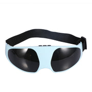 Light blue electric eye massager with black lens covers and adjustable black strap shown from front