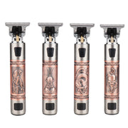 Four T9 clippers displayed side-by-side showing four distinct carved designs: skull, Buddha, dragon, and floral motifs on copper-bronze bodies with gunmetal tops