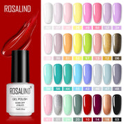 ROSALIND gel polish bottle on dramatic red background with glossy red liquid trail effect