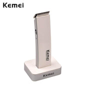 Kemei cordless hair clipper in cream color positioned in charging dock