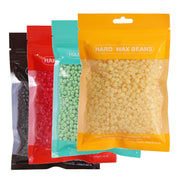 Four overlapping hard wax bean pouches in black, red, mint green, and golden yellow showing full product range