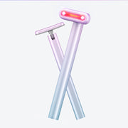 Product displayed as X-formation showing both roller and flat massager attachments on lavender gradient handles with pink LED lights glowing