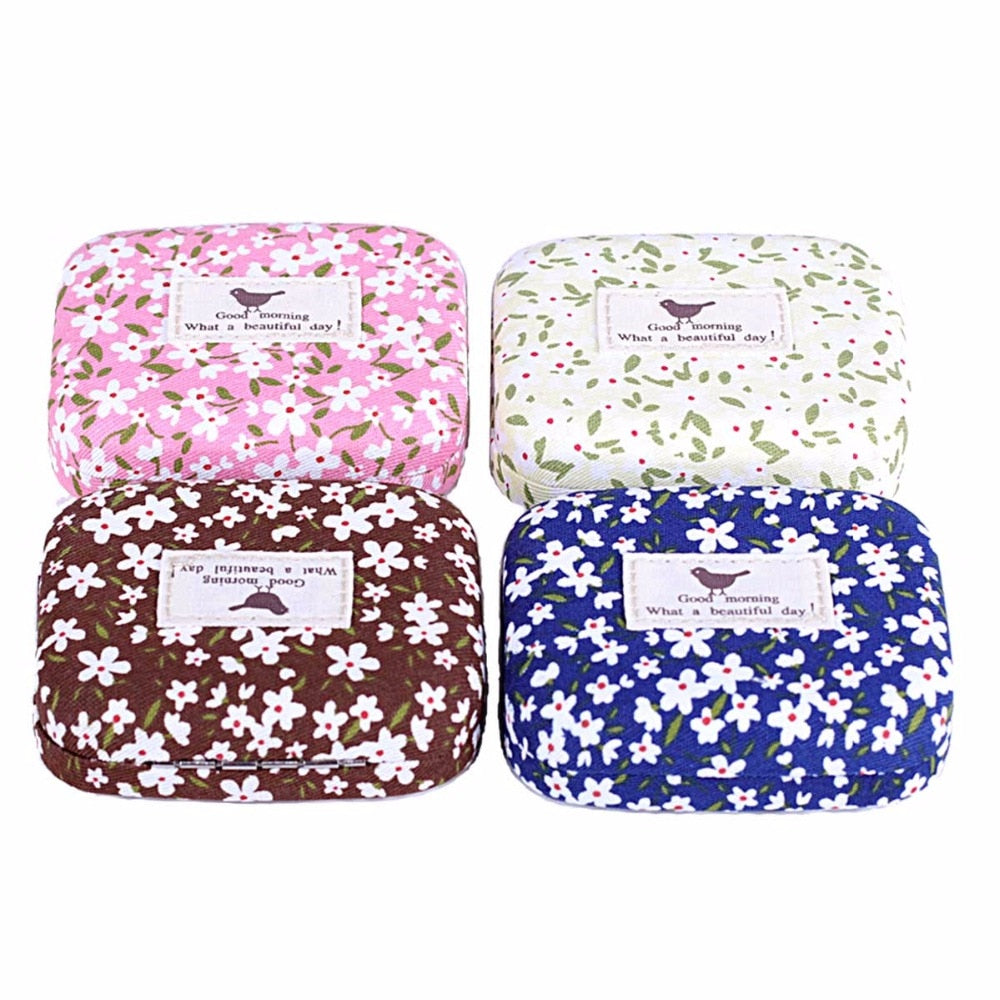 Four colorway options of floral eyelash cases arranged in a 2x2 grid showing pink, cream, brown, and blue variants