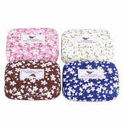 Four colorway options of floral eyelash cases arranged in a 2x2 grid showing pink, cream, brown, and blue variants