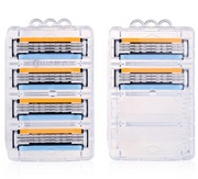Two clear plastic cases each containing 4 Gillette Vector 3 razor blade cartridges, front view showing orange and blue blade detail