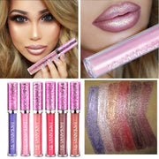 Woman with blonde hair wearing mauve-pink glitter lipgloss showing full face makeup with smoky eye