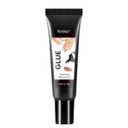 Yinikiz Glue 10g tube with black comb-tooth cap and clear label showing manicured hands and applicator tip