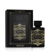 Lattafa Bade'e Al Oud Oud for Glory black and gold perfume bottle beside its matching black gift box on white background