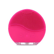 Front-facing hot pink silicone cleansing brush with textured bristle head and control buttons visible