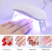 UV/LED nail lamp in use curing gel polish under bright purple light with hand positioned inside
