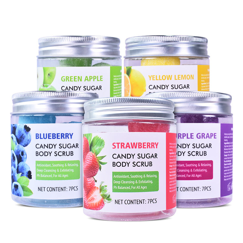 Five colorful candy sugar body scrub jars arranged in a staggered formation, each featuring a different fruit flavor with corresponding color-coded labels and imagery