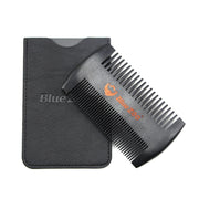 BlueZoo double-sided black pear wood beard comb resting against its black PU leather carry sleeve on white background