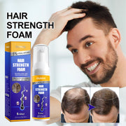 Smiling man with full dark hair touching his scalp, displaying confidence and healthy hair density