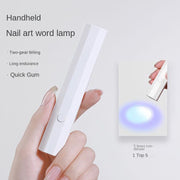 Handheld nail lamp in white held in hand demonstrating size and portability with feature list and blue LED light active