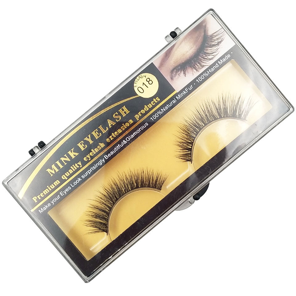 Premium Mink Eyelash packaging angled view showing golden label with black strip, cream colored lash bed, and visible lashes inside clear case