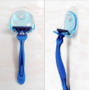Blue suction cup razor holder mounted on bathroom wall showing front and side views with a blue razor inserted