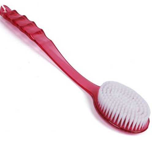 Pink long-handled bath brush with soft white bristles on neutral background