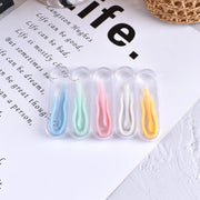 Five multicolored silicone tweezers lined up showing full color range: blue, green, pink, white, yellow in clear protective cases
