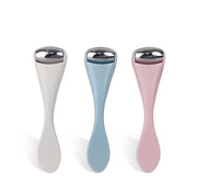 Three silicone rollers displayed in neutral, powder blue, and dusty pink finishes showing full product shape with chrome heads