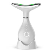 White EMS neck lifting device with whale-shaped paddle head, green LED accent, chrome band, and illuminated power button on teardrop base