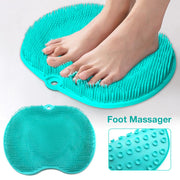 Female feet using turquoise foot massager mat in shower setting, demonstrating hands-free design and bristle contact
