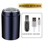 Navy blue cylindrical electric shaver with metallic shaving head, shown with included cleaning brush and USB charging cable