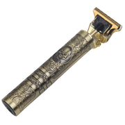 Ornate brass electric hair clipper with gold blade head shown at 45-degree angle