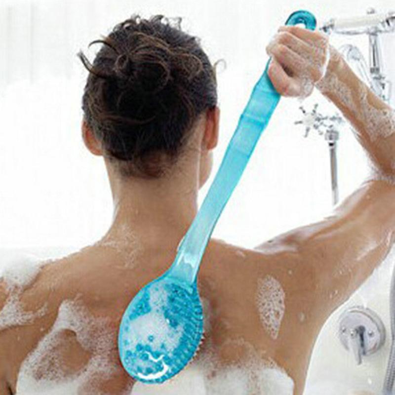 Person using blue bath brush in shower on wet skin and soapy back