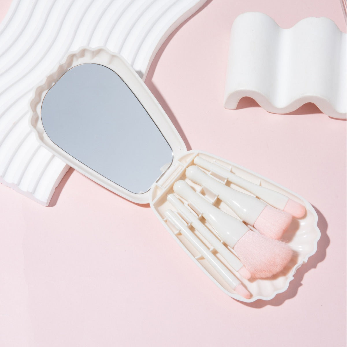 Open shell case displaying interior mirror and organized brush storage compartments