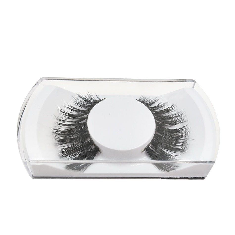 False lashes displayed in clear rectangular plastic case, showing lash density and wispy construction
