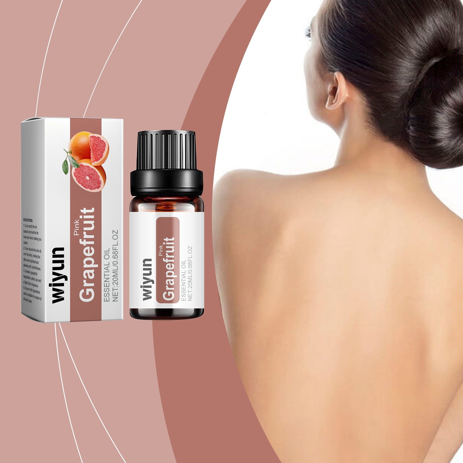 Woman's bare back and shoulders with grapefruit essential oil bottle and packaging on dusty rose background