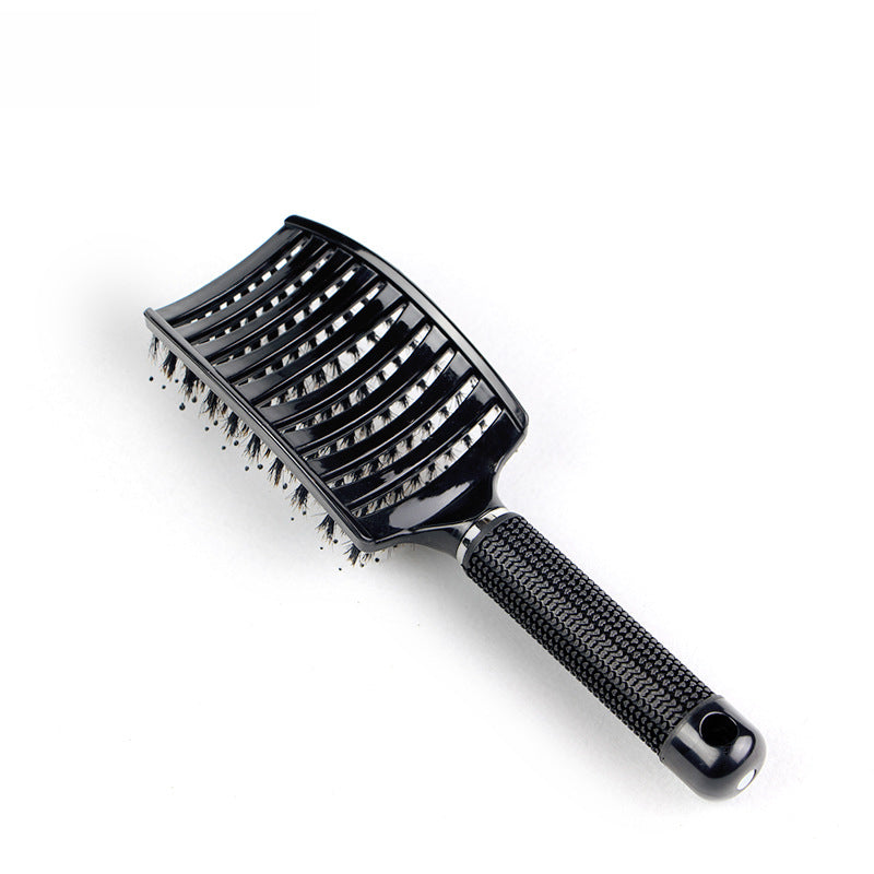 Single black paddle hairbrush at angle showing vented head design with nylon bristles and textured grip handle