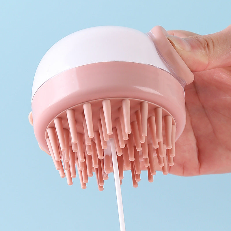 Overhead and side view of both brushes showing the dense silicone bristle array on grey brush and the side-mounted flip dispenser on pink brush