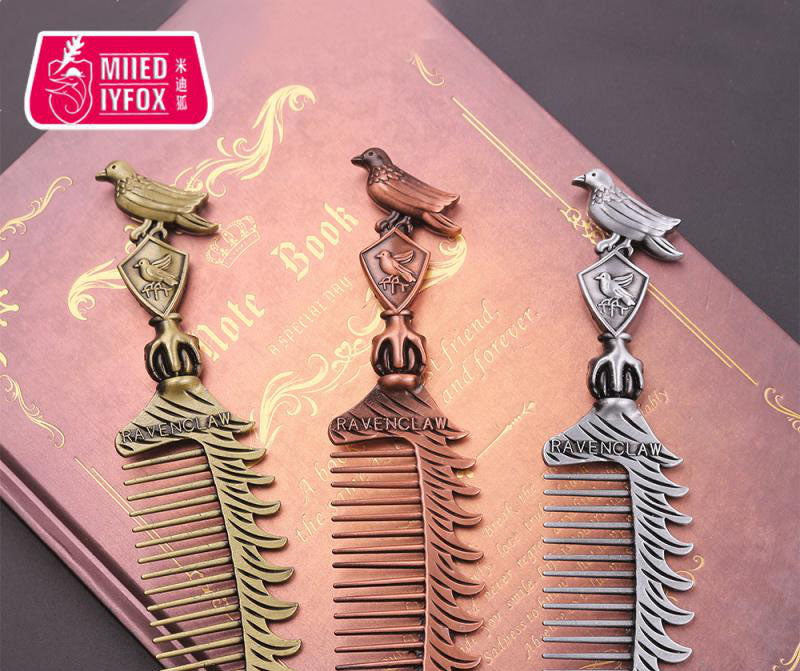 Silver comb showcasing sculptural bird perch and house crest embellishments from angled perspective