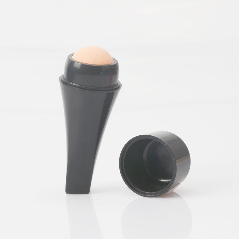 Cobalt blue volcanic stone oil-absorbing ball with cap removed showing the porous stone surface and hollow handle chamber