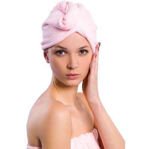 Portrait of woman with pink hair towel wrap showing confident beauty routine aesthetic