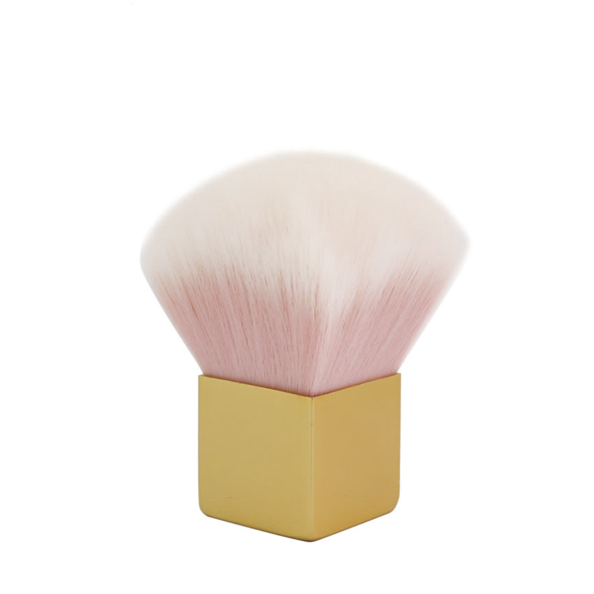 Front-facing product shot of the pink kabuki brush with fan-shaped bristle head and square gold ferrule standing upright