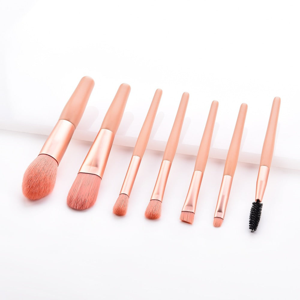 Extreme close-up of dense coral-pink bristles on the large powder brush and smaller brushes