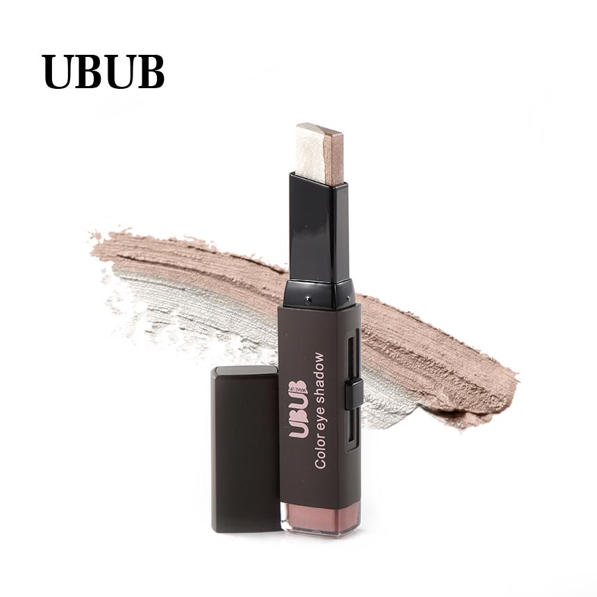 Extended eyeshadow stick with visible creamy texture and shimmer payoff, swatched on warm beige background