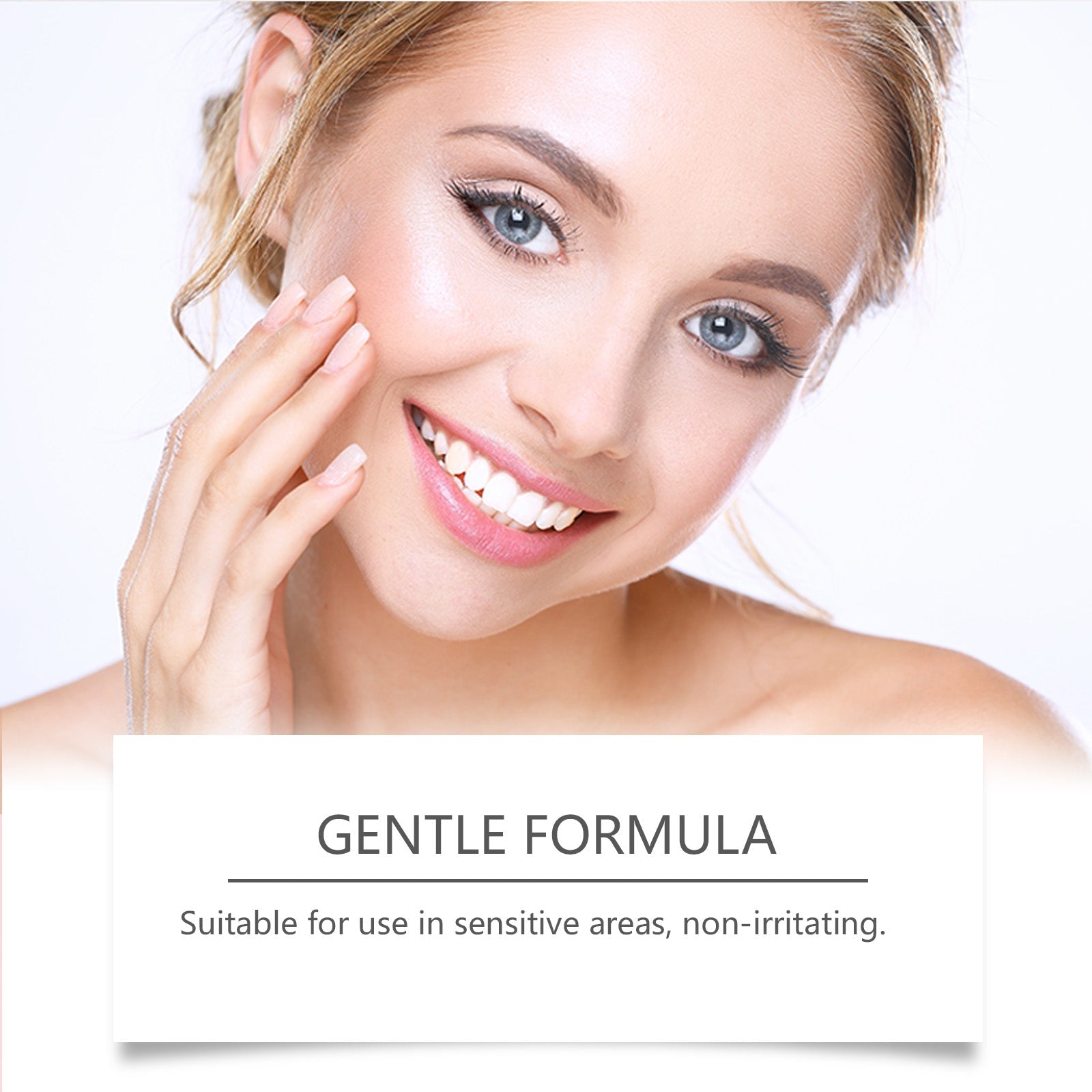 Young woman with clear, glowing skin touching face with manicured nails smiling at camera