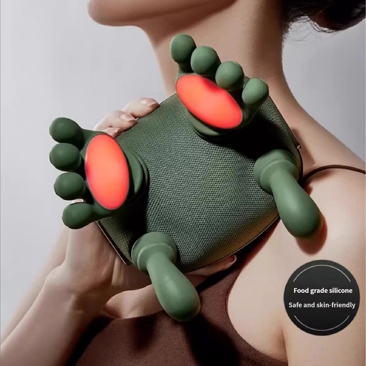 Close-up of massager worn on neck showing dual infrared heating pads glowing red and food-grade silicone finger nodes